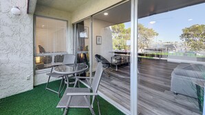 A covered patio with a table and chairs, a grill, and a view of the surrounding area. - Cozy Couple's Condo! Walk to Old Town Scottsdale (Scottsdale)