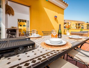 Enjoy al fresco dining in this charming outdoor space, complete with a grill and seating for four.