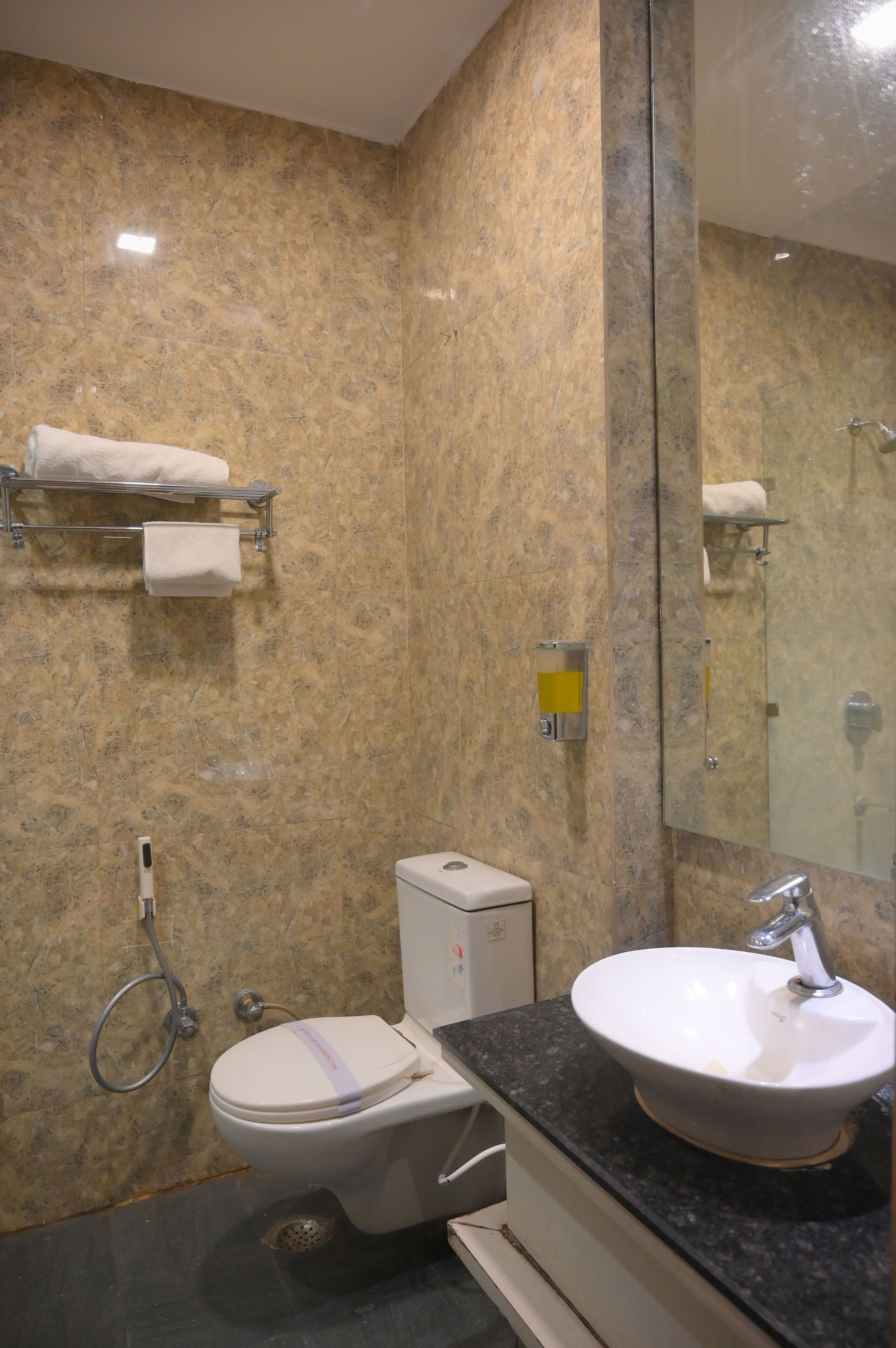 A bathroom with a toilet, sink, and shower.