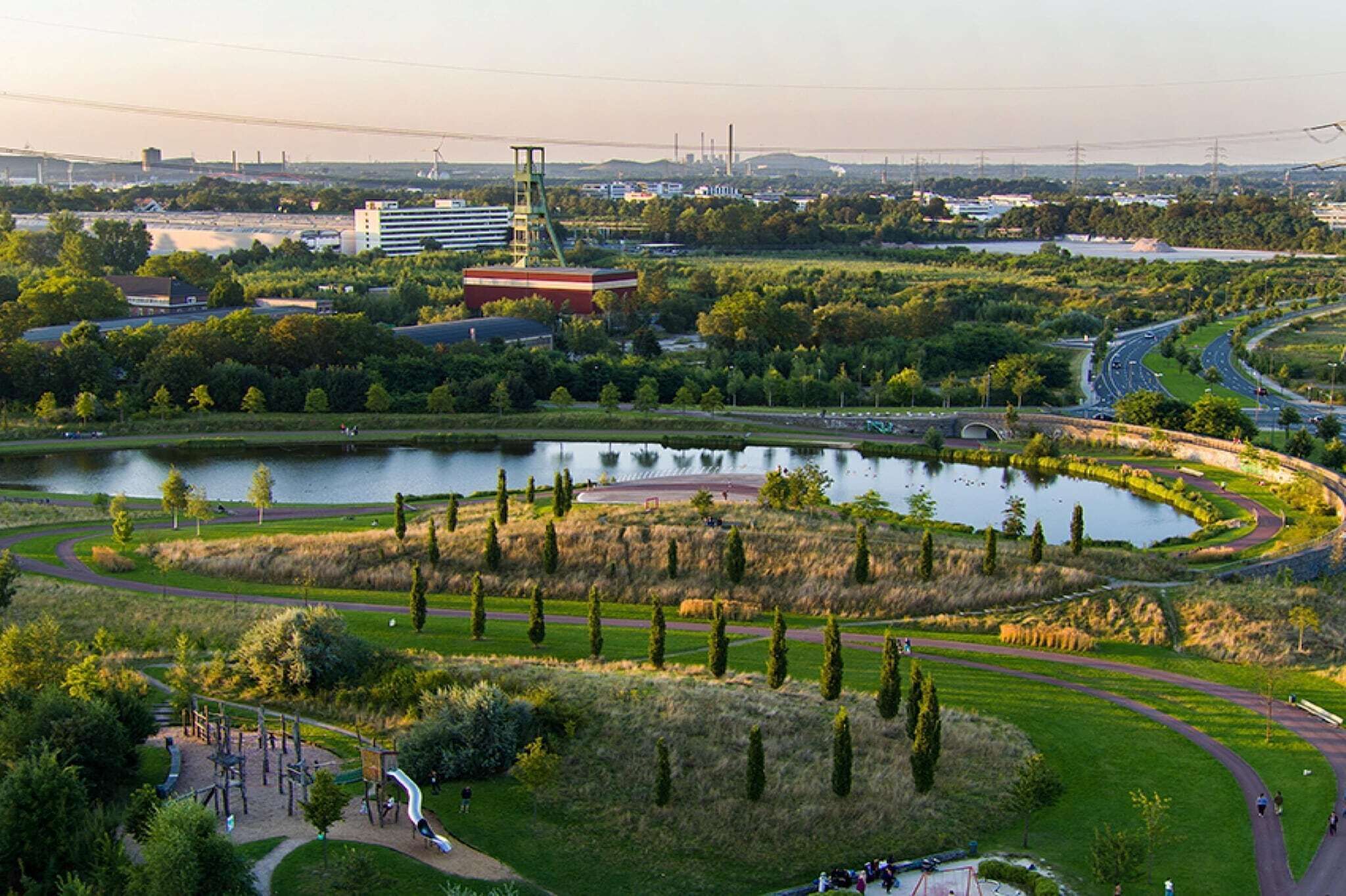 A park with a lake, walking paths, and playgrounds.