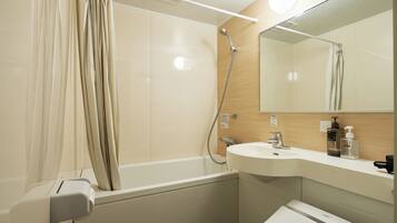 A modern bathroom with a bathtub, a sink, and a mirror.