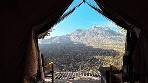 A tent with a view of a mountainous landscape. - Alam Caldera Camp & Resto  (Kintamani)