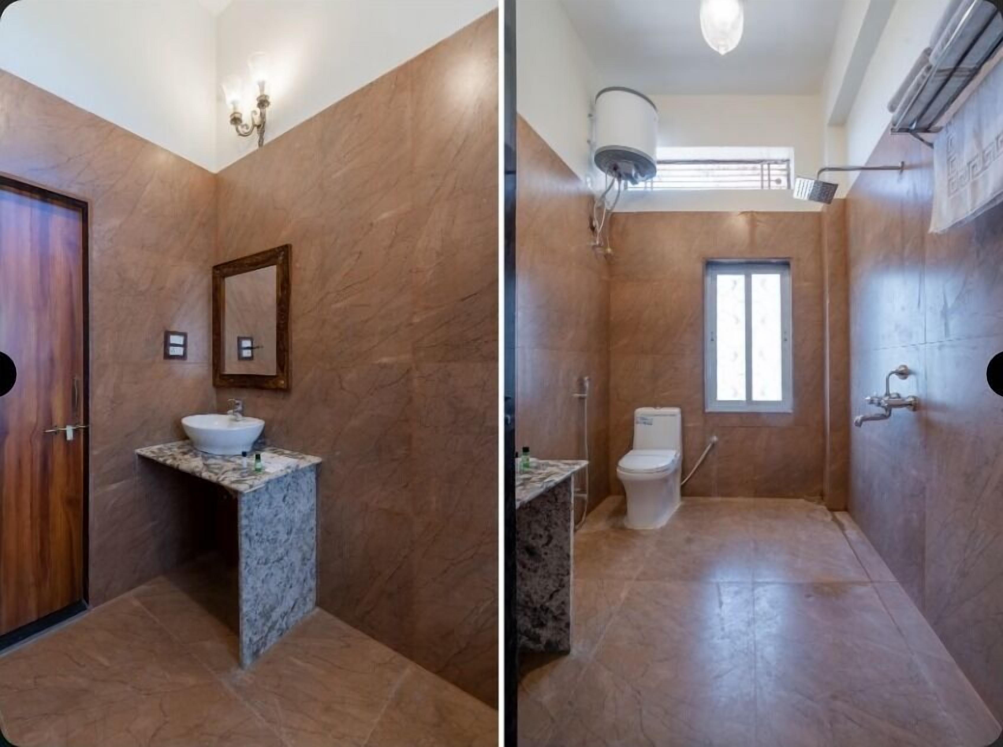 A bathroom with a marble sink, a toilet, and a shower.
