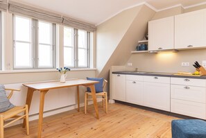 Enjoy cooking in this well-equipped kitchen with an oven, dining table, and ample countertop space.