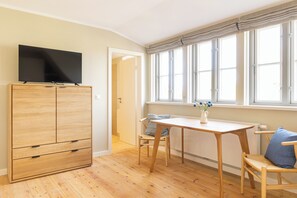 Relax in this stylish room with a large window, flat-screen TV, and comfortable seating area.