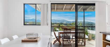 Enjoy a meal on the balcony with a view of the surrounding mountains.
