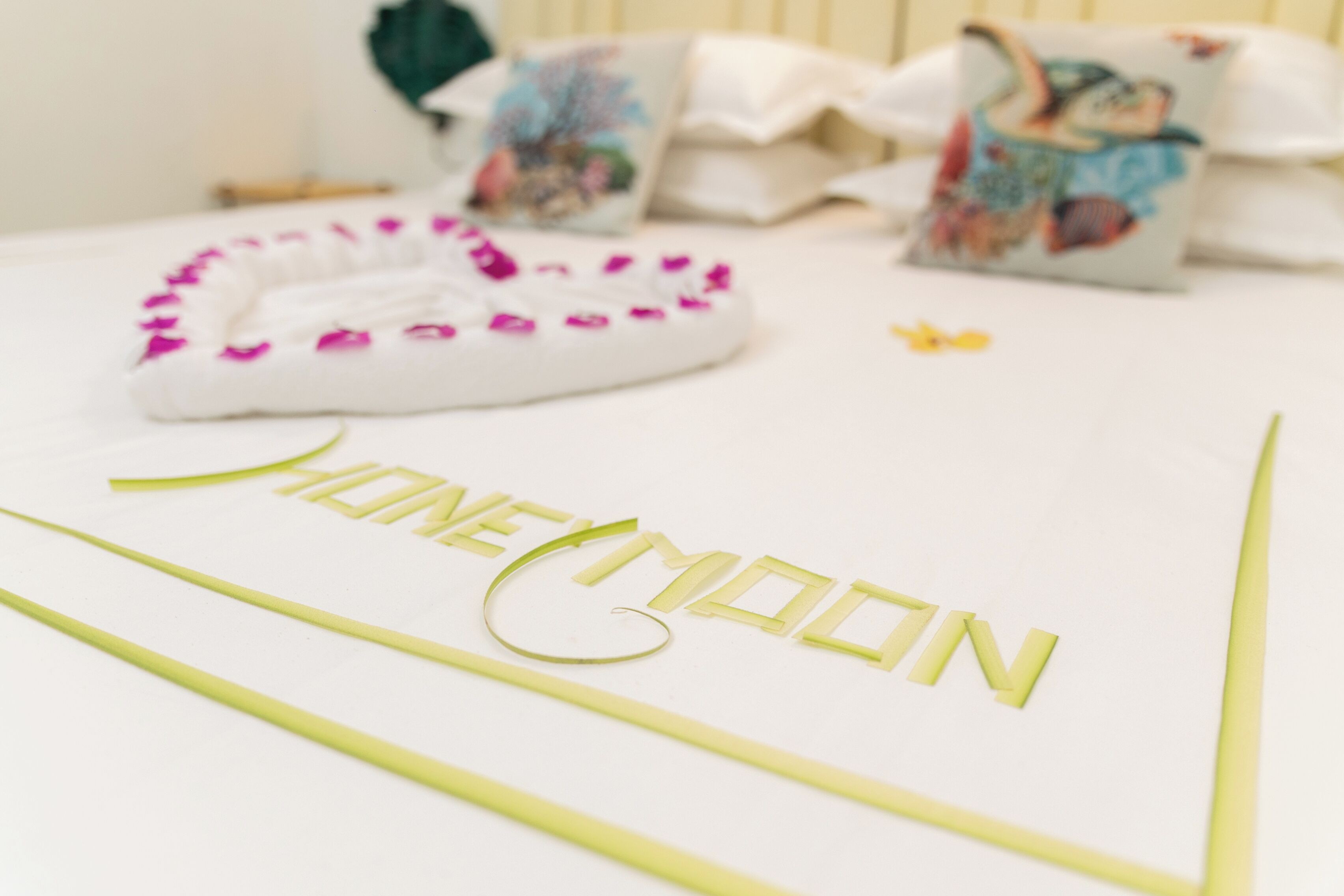 Una cama con una colcha blanca y una decoración que deletrea 
