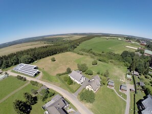 Rural property with a large building, smaller homes, and well-manicured grounds.