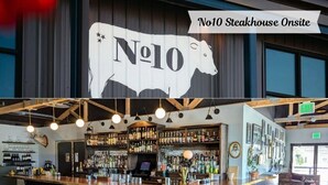 A bar area with a large No10 Steakhouse sign, bar stools, and a well-stocked liquor shelf.
