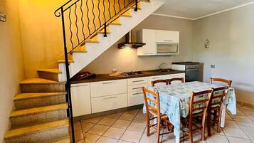 Apartment | Private kitchen | Full-sized fridge, stovetop, cookware/dishes/utensils