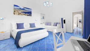A modern bedroom with a bed, a sofa, a desk, and a laptop. - BlueVista Home -Terrace Jacuzzi/Hot Tub (Positano)
