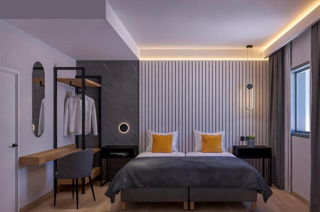 A modern bedroom with a bed, bedside tables, a desk, and a mirror.