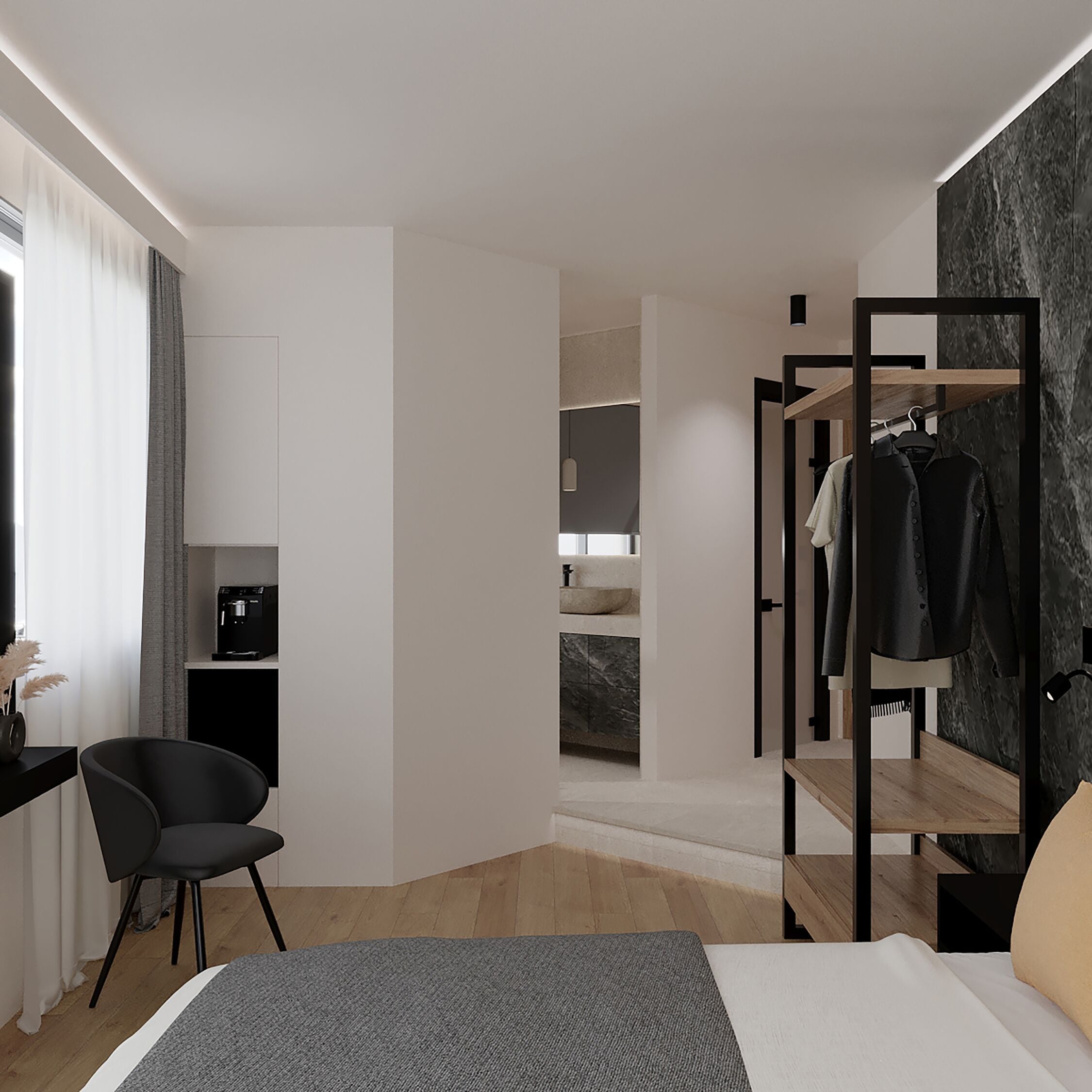 A modern hotel room with a bed, a desk with a computer, a chair, a wardrobe, and a bathroom visible through an open door.