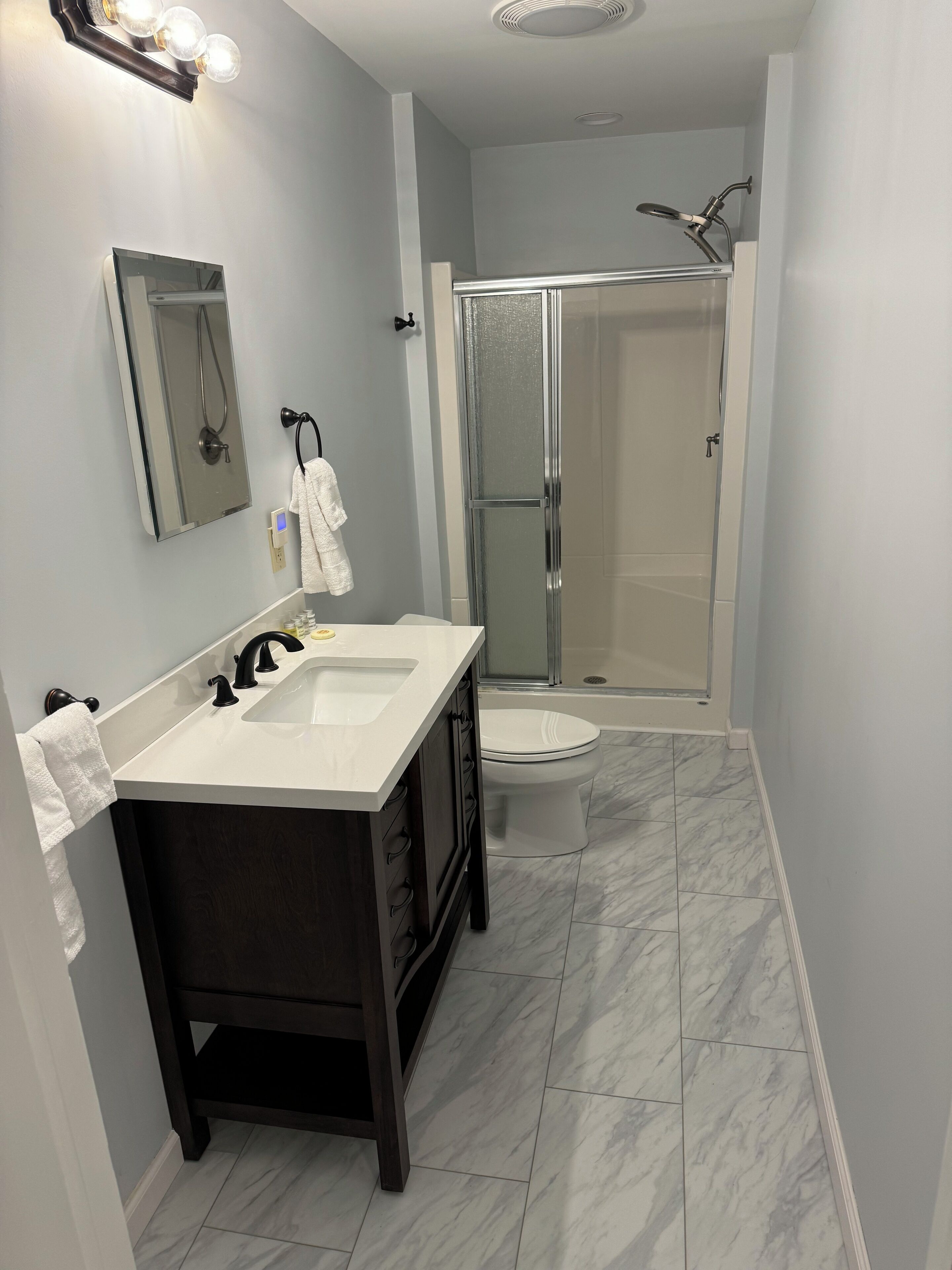 Shower, hair dryer, towels, toilet paper