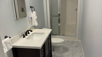 Shower, hair dryer, towels, toilet paper