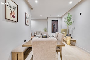 Enjoy meals with family and friends at this stylish dining area, featuring a long table and comfortable seating for four.