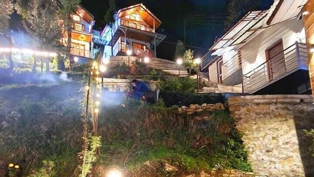 A multi-story building with a stone facade and a balcony. - The Mystic Pines (Nainital)