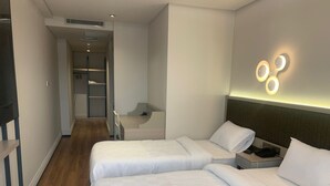 A hotel room with two beds, a desk, and a walk-in closet. - Theodosius Hotel (Istanbul)