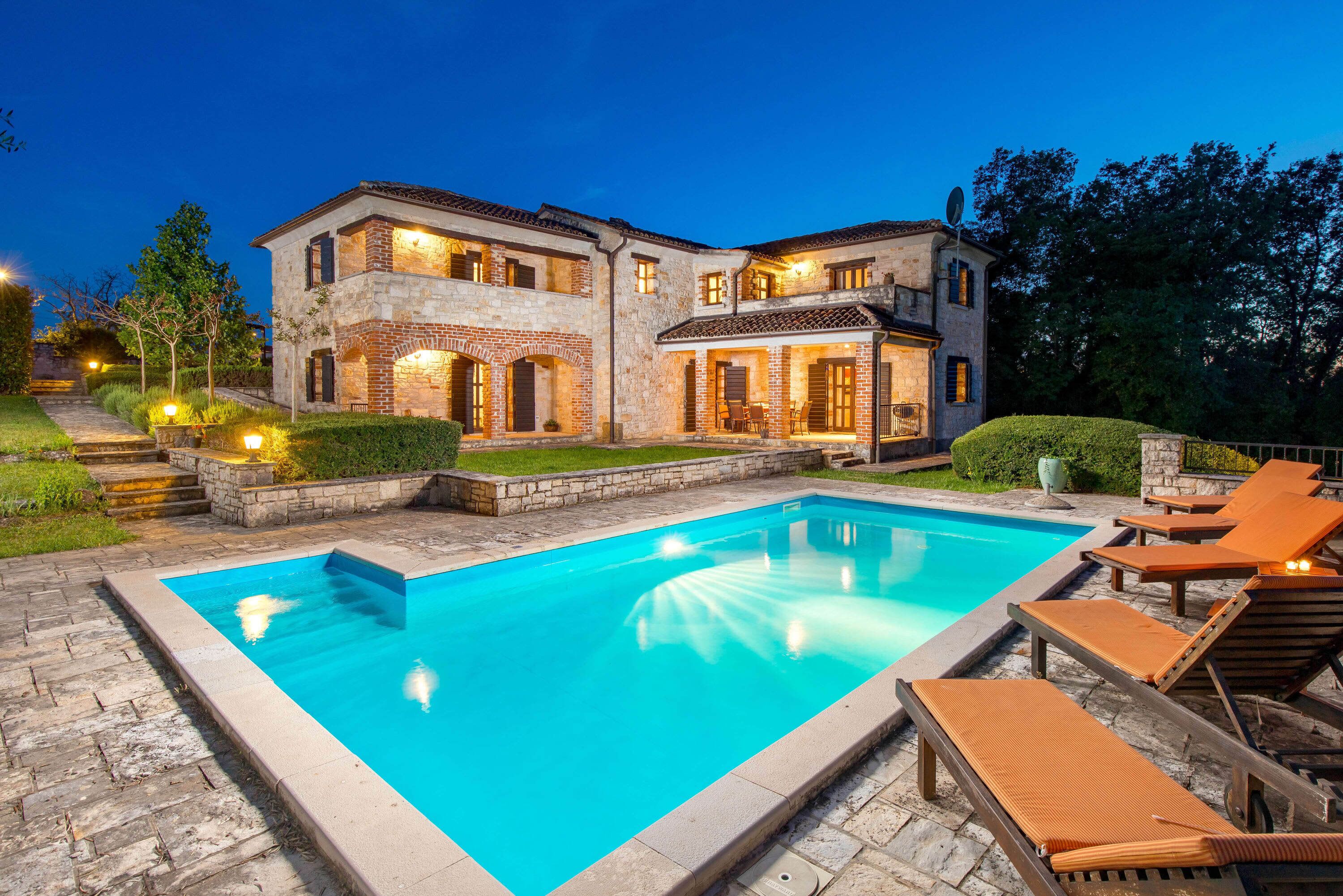 A large house with a swimming pool and outdoor seating.