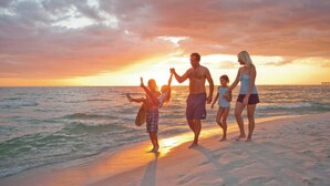 A family walking on a beach during sunset. - New Luxury Beach Home with Private Pool (Panama City Beach)