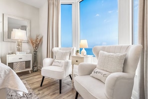 Relax in comfort with a clear view of the sky, plush armchairs, and soft lighting.