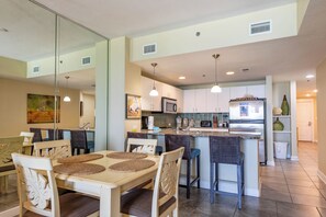 Enjoy meals in the kitchen with a central island and dining area featuring a table and four chairs.