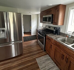 Enjoy cooking in this well-equipped kitchen with a refrigerator, microwave, and stove.
