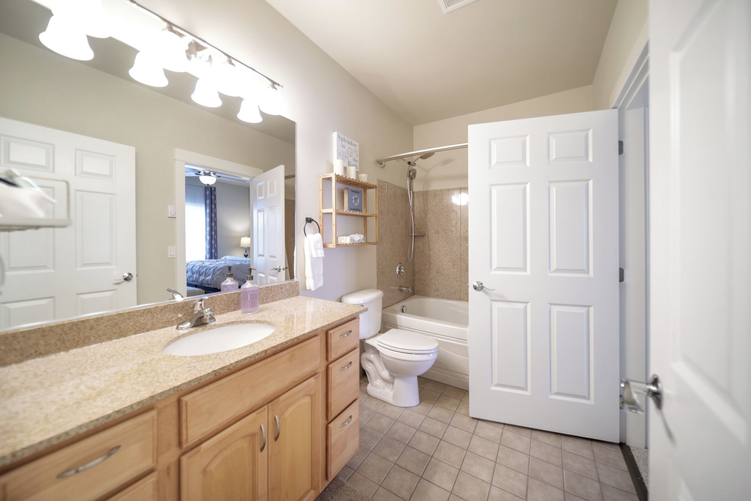 A bathroom with a sink, toilet, and bathtub.