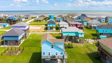 A coastal residential area with houses featuring balconies and waterfront views.