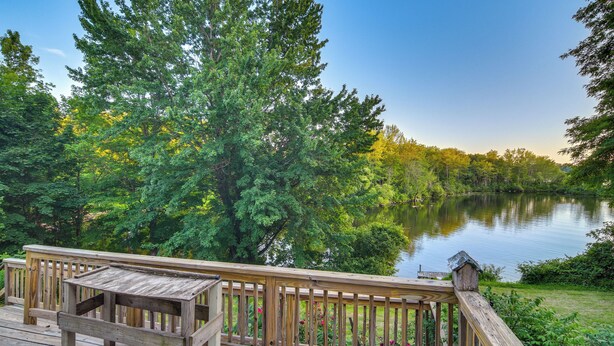 A wooden deck with a table and chairs overlooking a lake surrounded by trees. - Lakefront Maine House ~ 4 Mi to Colby College (Oakland)
