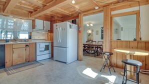 A wooden interior with a kitchen, dining area, and bar. - Lakefront Maine House ~ 4 Mi to Colby College (Oakland)