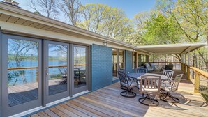 A deck with a table and chairs, overlooking a body of water. - Tranquil Lakefront Greers Ferry Escape w/ Fire Pit (Higden)