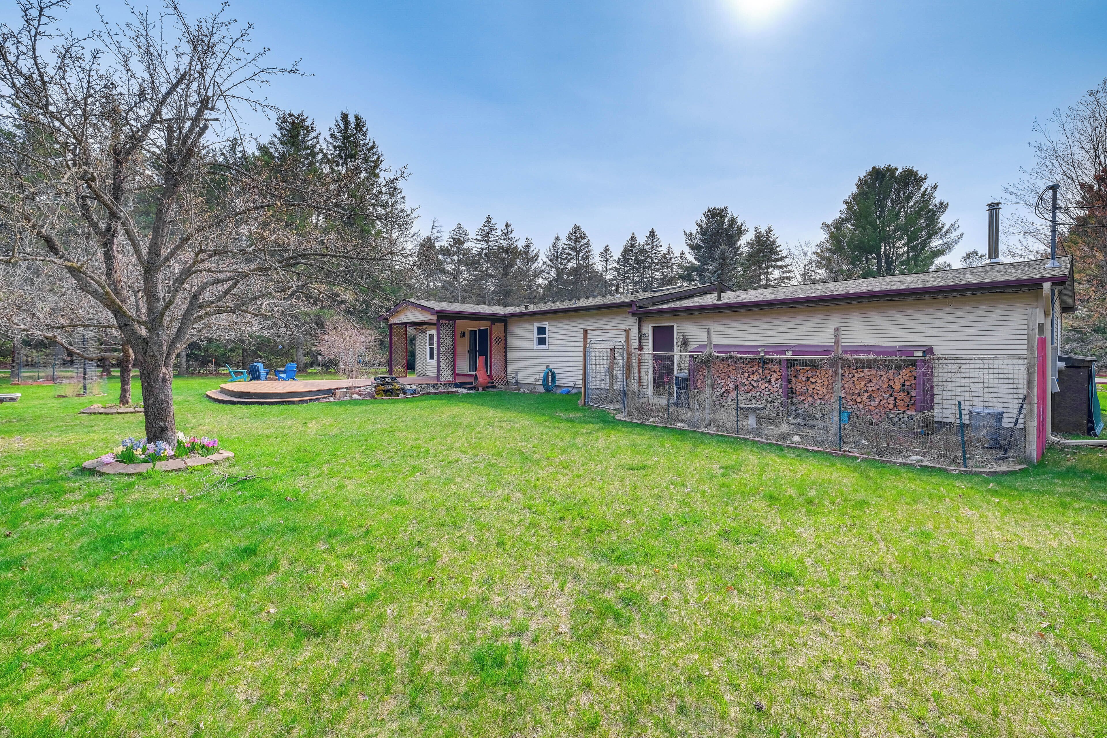 A single-story house with a fenced yard, a small porch, and a garage.