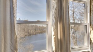 A window with a view of a body of water and trees. - Lakefront Oakland Vacation Rental w/ Dock + Views! (Oakland)