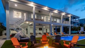 A multi-story building with outdoor seating and a pool. - Seaside Serenity~ Luxury Waterfront Pool Home w/ 35` Dock (Marathon)