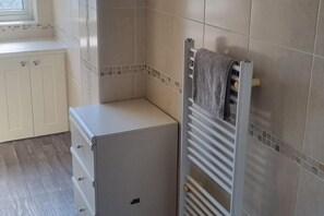 A small, enclosed bathroom with a towel rack, a radiator, and a cabinet. - Doncaster Dream House Retreat- Sleeps 9 (Doncaster)