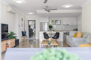 A modern living space with a kitchen, dining area, and seating area.