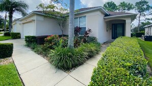 A single-story house with a front yard, a driveway, and a garage.