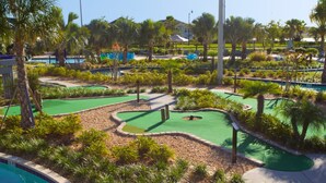 A golf course with multiple greens and a pool area. - Brenda's Storey Lake Resort Townhome (Kissimmee)