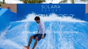 A person surfing on a wave at Solara Resort. - Jodie's Luxury Solara Home (Kissimmee)