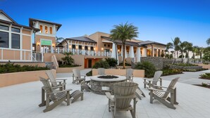 A resort with a fire pit and Adirondack chairs in the outdoor area. - Jodie's Luxury Solara Home (Kissimmee)