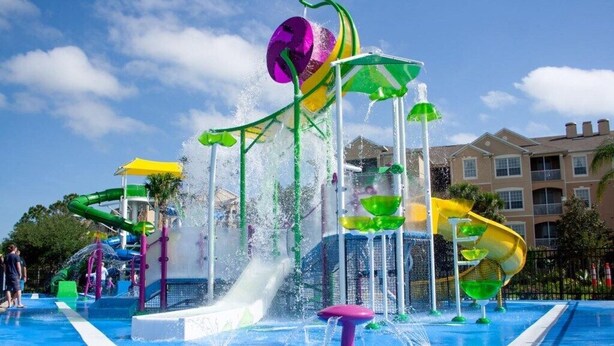 A water park with multiple slides and water features. - Comrow Castle Magical Getaway (Kissimmee)