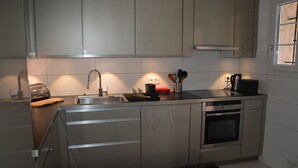 A modern kitchen with stainless steel appliances, a built-in oven, and a dishwasher. - Faïza  - Four Bedroom Villa, Sleeps 8 (Roquebrune-sur-Argens)