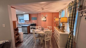 A compact kitchen with a dining area, a built-in oven, and a small island.