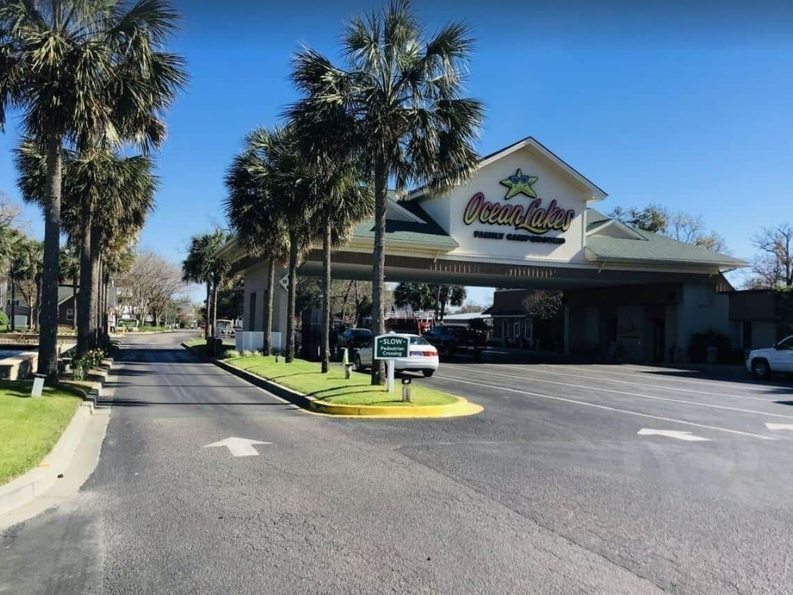 A hotel named Ocean Lakes with a sign indicating a slow-traffic crossing.