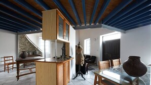 A room with a wooden cabinet, a glass table, and a stone wall. - AMPLE PLACES Monadiko House
Traditional house in the center of Lefkara village (Pano Lefkara)