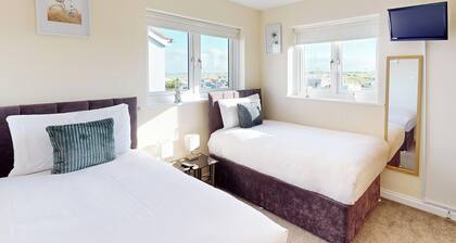 Discover coastal bliss at The Dunes, your perfect family haven by Beadnell Bay.