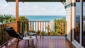 A wooden deck with a table and chairs, overlooking a coastal view. - Allawah Cottage - Historic Beachside Retreat With Pippi Beach Views - Holiday Yamba (Yamba)