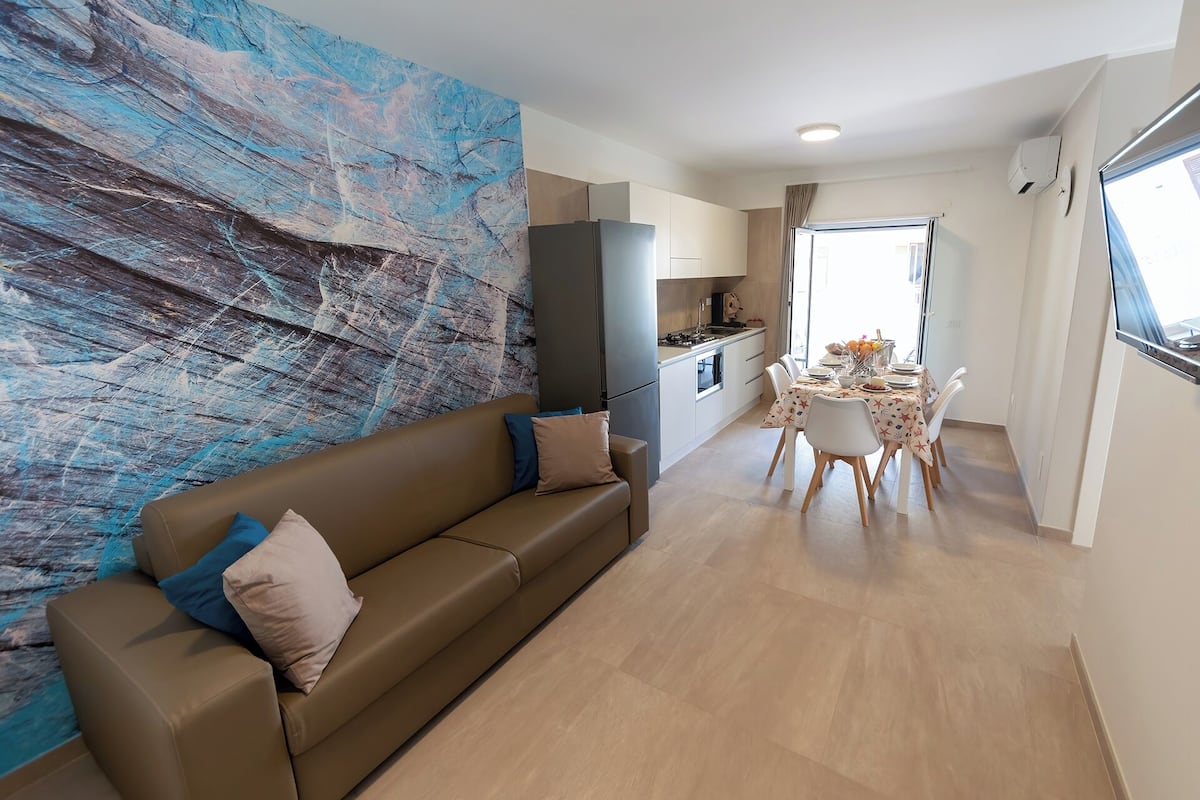 Deluxe Apartment | Living area | 32-inch LED TV with satellite channels
