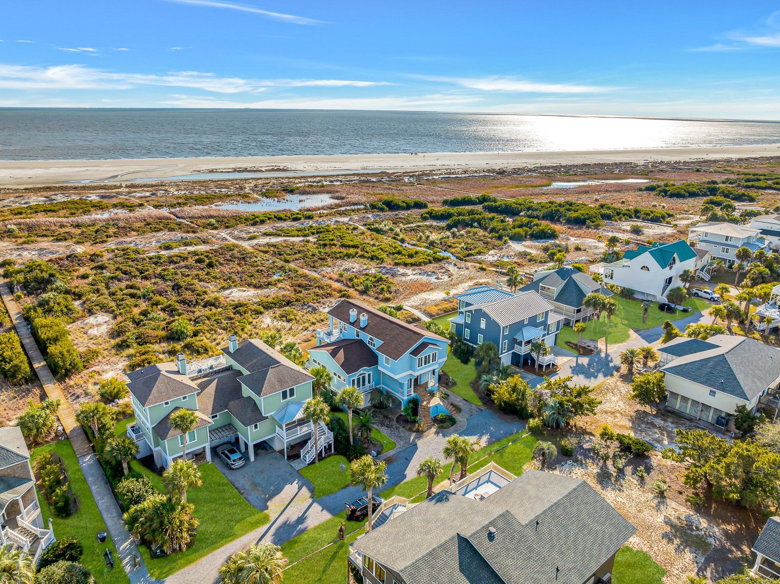 Une zone résidentielle côtière comprenant des maisons, une plage et un paysage marécageux.